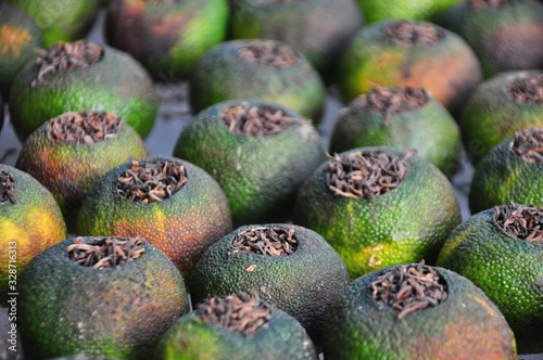 Xinhui mandarin tea is a special product of Xinhui, Jiangmen, south China’s Guangdong province. A gutted Tangerine/ Mandarin stuffed with dried red tea. photo