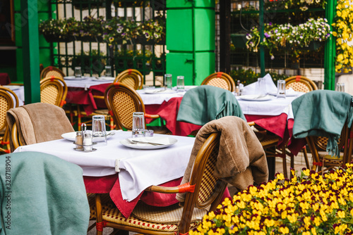 Beautiful retro styled cafe/ restaurant exterior - outdoor chairs and tables and fresh flowers decoration