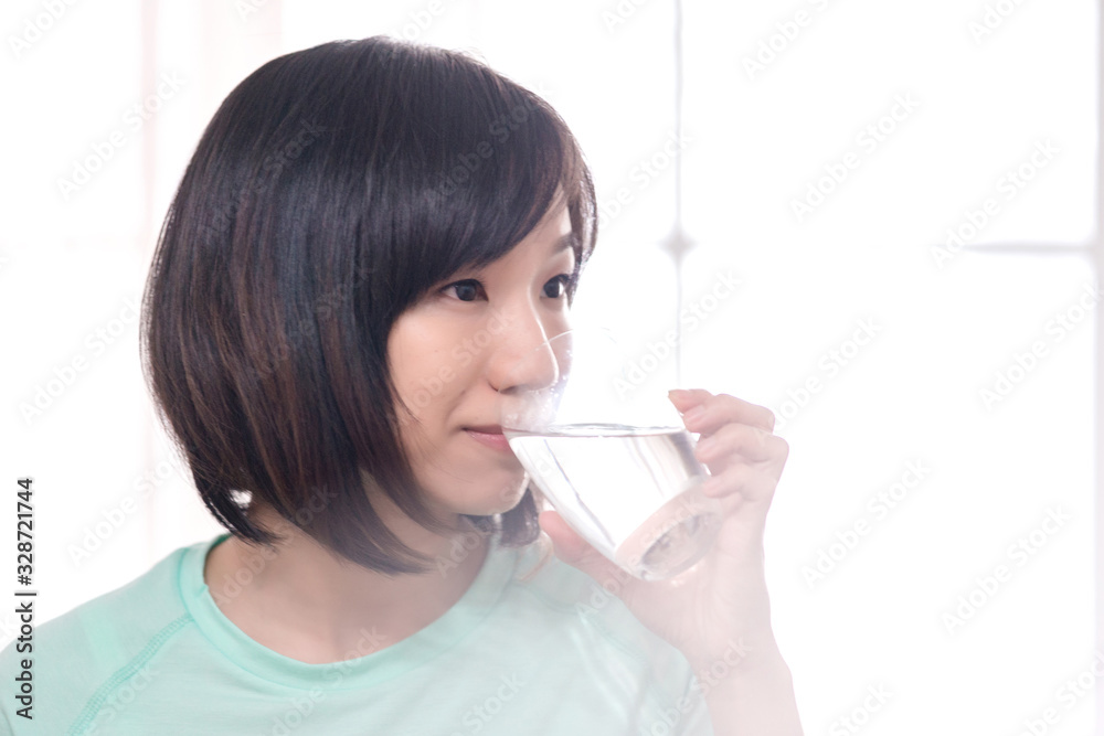 young attractive asian woman who drinks water young attractive asian woman who drinks water