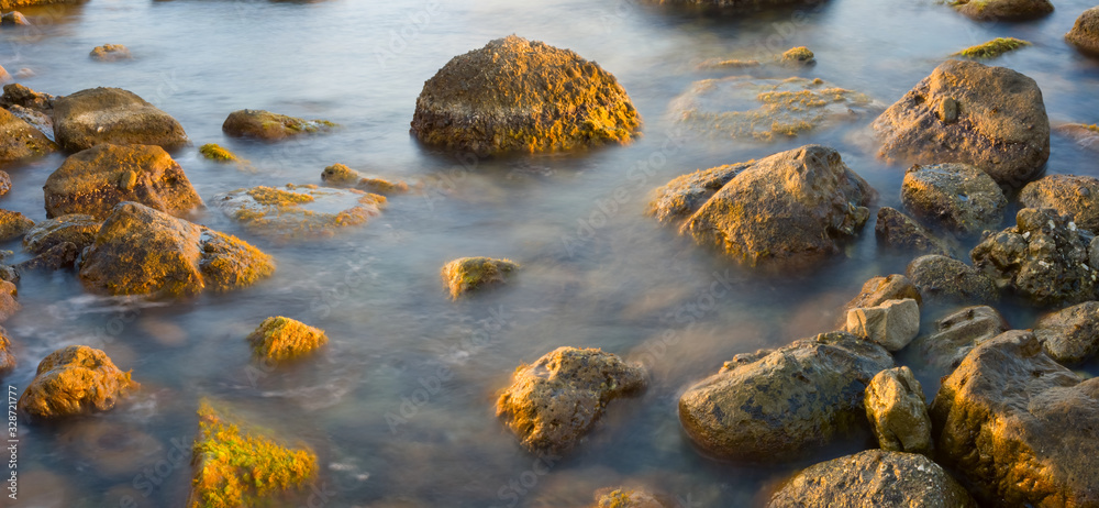 closeup stones in a sea near a coast closeup stones in a sea near a coast