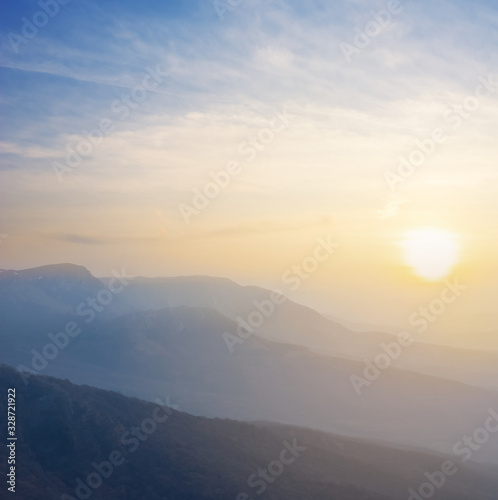 mountain chain silhouette in a early morning mist © Yuriy Kulik