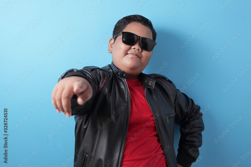 Fat rich Asian boy smiling at camera with proud Fat rich Asian boy smiling at camera with proud