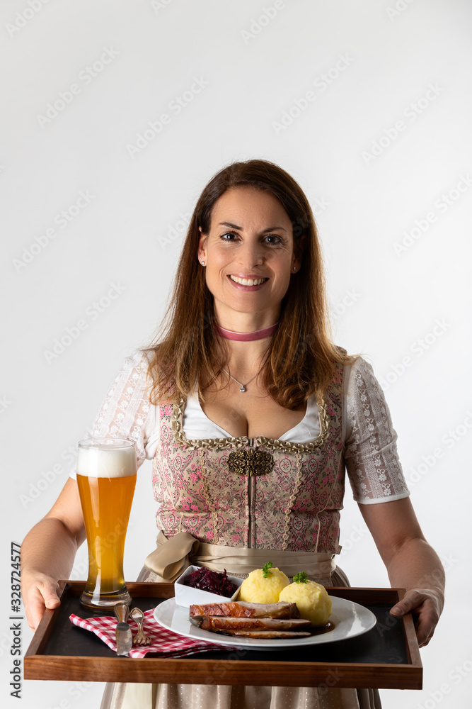woman in a bavarian dirndl with a tray woman in a bavarian dirndl with a tray