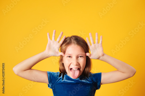 Young Redhead Preteen Girl Showing Tongue To Camera