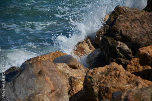 The sea splashing rocks on the shore