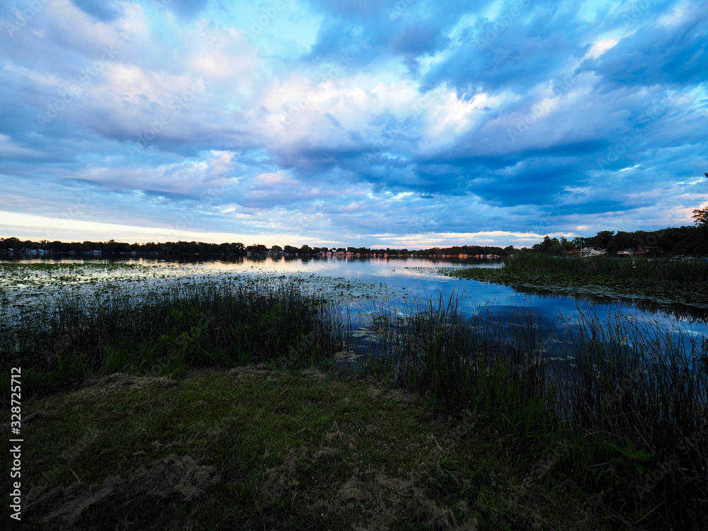 Lake with blue skies and clouds reflected
