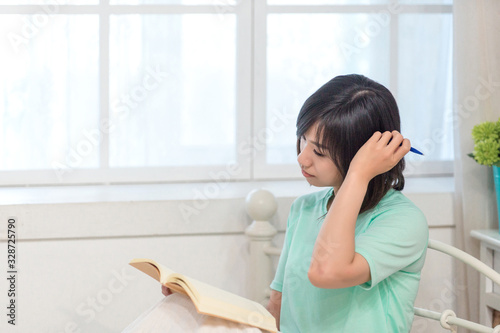Young girl studying with text book