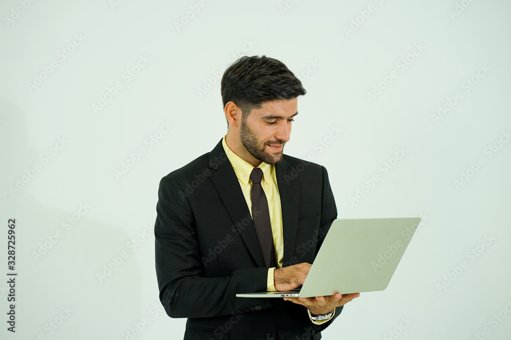 portrait of caucasian young businessman wearing suit with the mobile phone and computer looked at the camera to have the teleconference with the office meeting work from home during virus pandemic portrait of caucasian young businessman wearing suit with the mobile phone and computer looked at the camera to have the teleconference with the office meeting work from home during virus pandemic