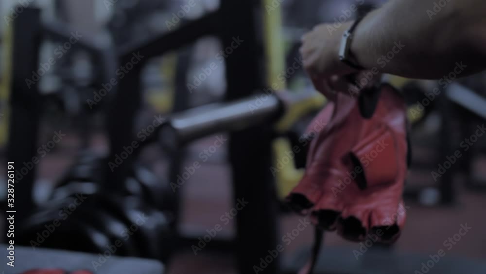 Athletic sexy girl takes gloves from a bag Athletic sexy girl takes gloves from a bag