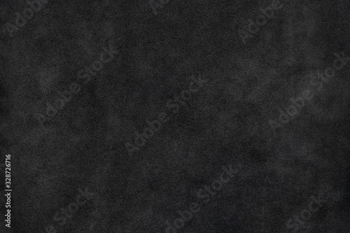 Old black natural suede leather soft touch textured background photo