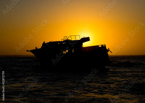 sunset behind shipwreck of japanese trawler meisho maru no 38 near cape agulhas photo