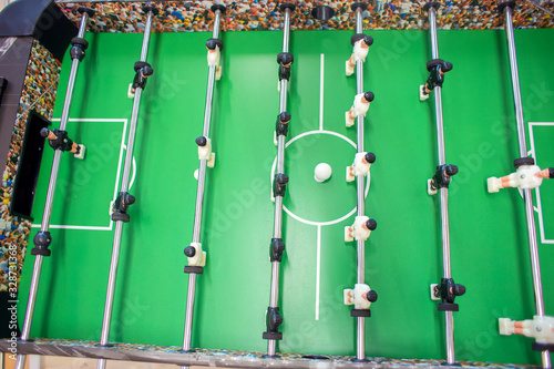 Big Game foosball top view. Playing table football in a bright room