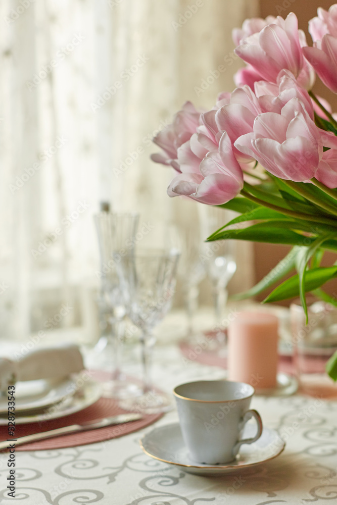Decor and spring table setting is a vase with pink tulips Decor and spring table setting is a vase with pink tulips