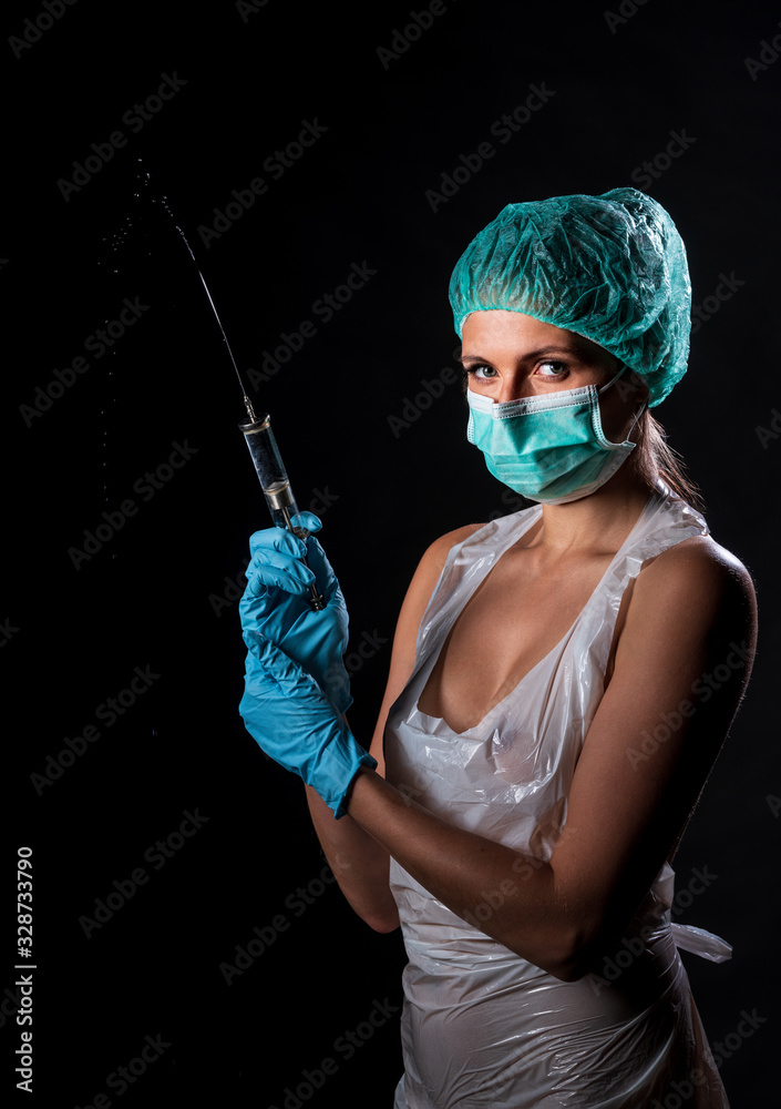 Sexy doctor in medical mask make protective injection. Naked nurse prepares  syringe. Medic in disposable medical clothing. preparing vaccination  against for a pandemic and flu season. foto de Stock | Adobe Stock
