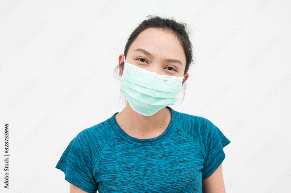 Portrait Asian woman wearing medical mask on white background.Girl wearing mouth mask against air smog pollution. Concept of corona virus quarantine or covid-19.Protection against virus infection