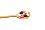 Many types of medications are on the wooden spoon.