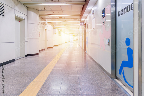 Fototapeta Naklejka Na Ścianę i Meble -  Walkway and many rooms to toilet, Perspective Long corridor with yellow color line