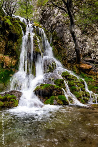 Fototapeta Naklejka Na Ścianę i Meble -  Beautiful waterfall in the forest with green moss, Caras Severin county, Beusnita National Park, Cheile Nerei, Bozovici, Romania