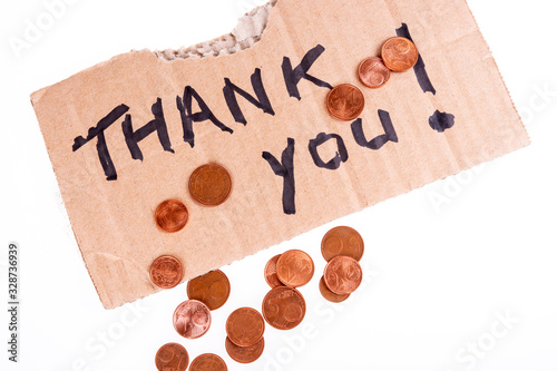 Cent coins and thank you written on the cardboard