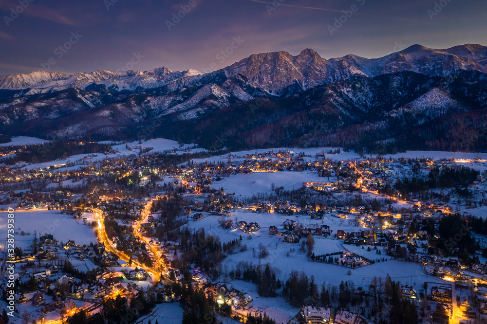Stunning illuminated Zakopane city in winter at night, aerial view