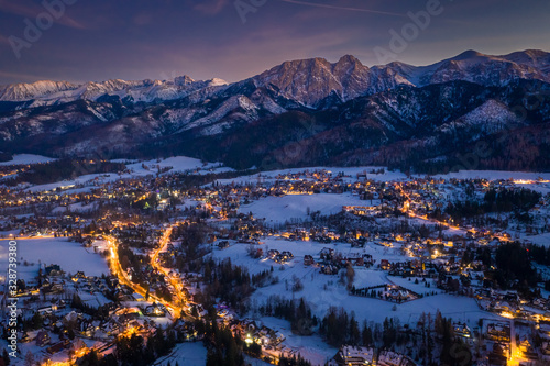 Stunning illuminated Zakopane city in winter at night, aerial view