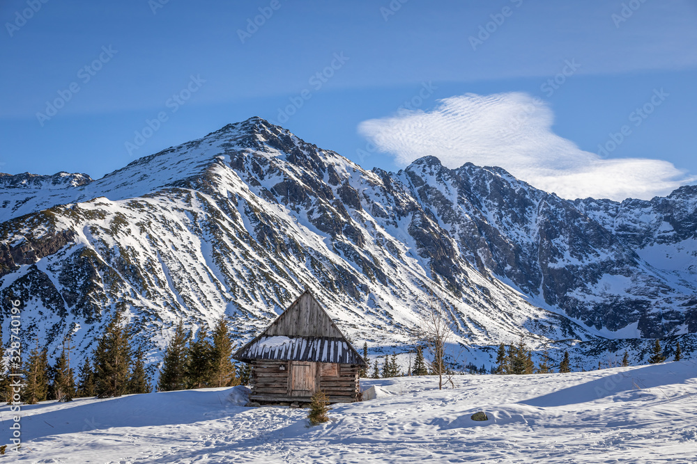 Snowy wooden cottage in Gasienicowa valley in winter