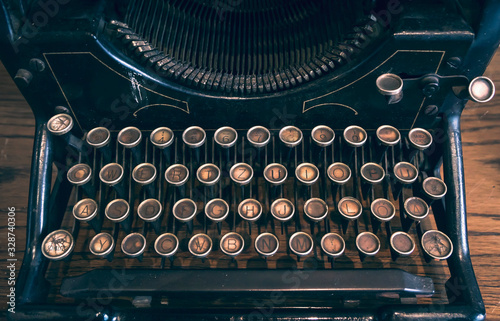 Vintage typewriter machine. Color graded image of rustic typing kayboard. photo