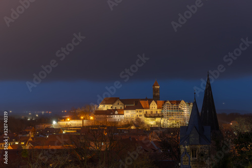Scenic view over the historic old town of Quedlinburg with castle hill in Germany in the evening during blue hour