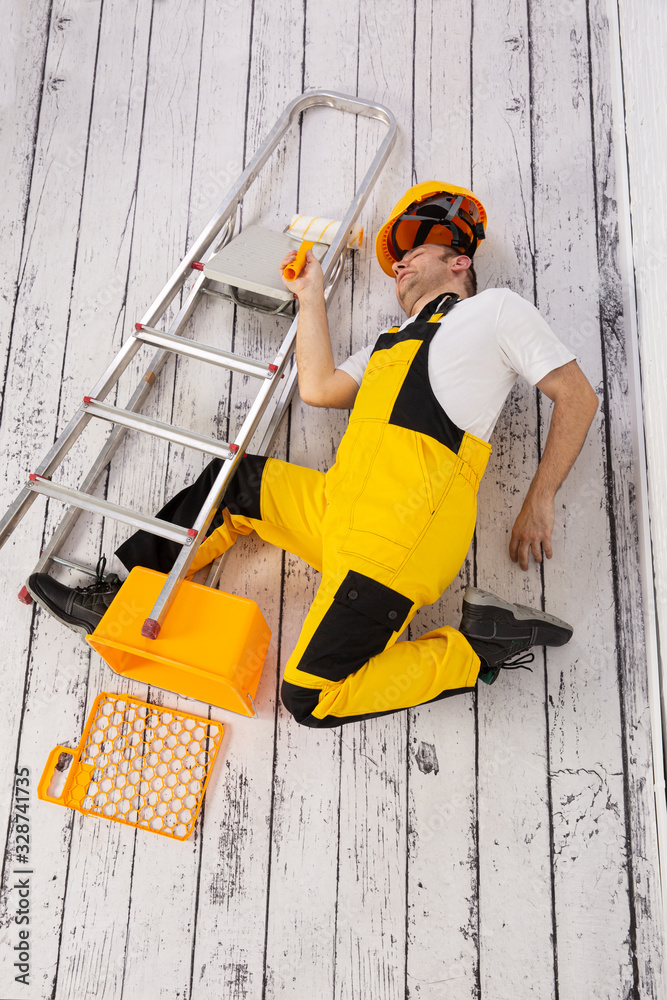 Fototapeta premium Construction accident. Fall from a ladder.