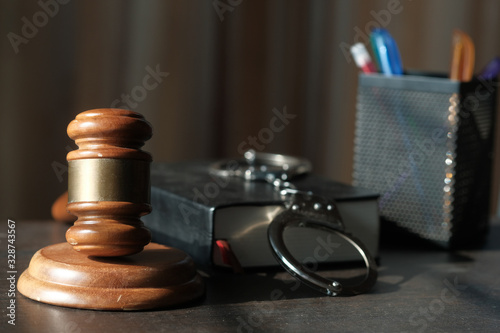 Close up of gavel , book and handcuff on table 