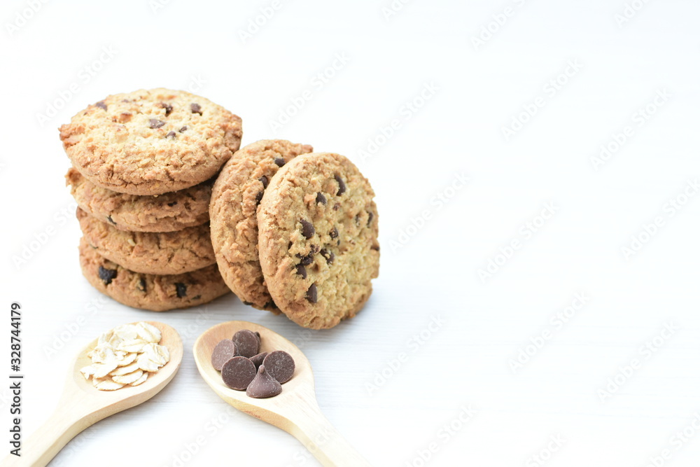 Oatmeal cookies and chocolate chips on light background Oatmeal cookies and chocolate chips on light background