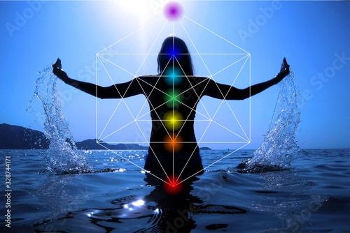 Celebrating life - Beautiful woman on the beach at sunset celebrating life with Sacred geometry Metatron's cube and 7 chakras
