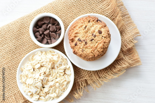 Oatmeal cookies and chocolate chips on cloth background