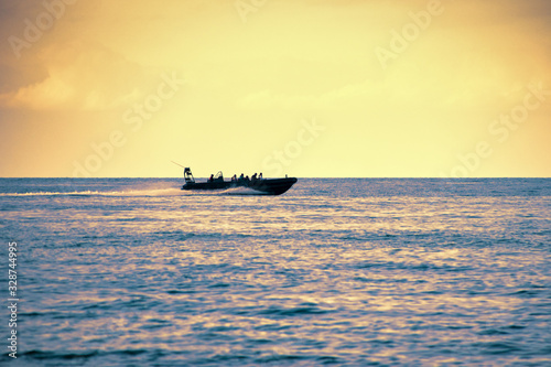 Speedboat silhouette in the golden evening light