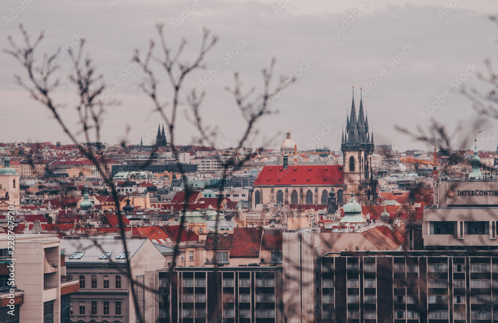 Moody Photo of Prague panorama with medieval church and red roofs taken from Letná hill on the moody February afternoon