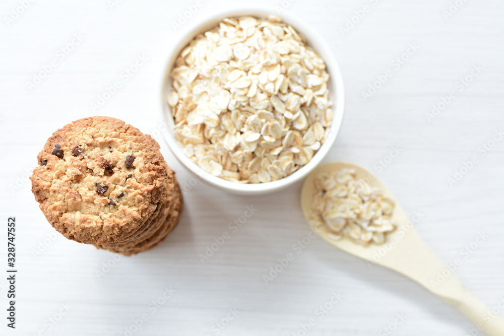 Oatmeal cookies and chocolate chips on light background Oatmeal cookies and chocolate chips on light background