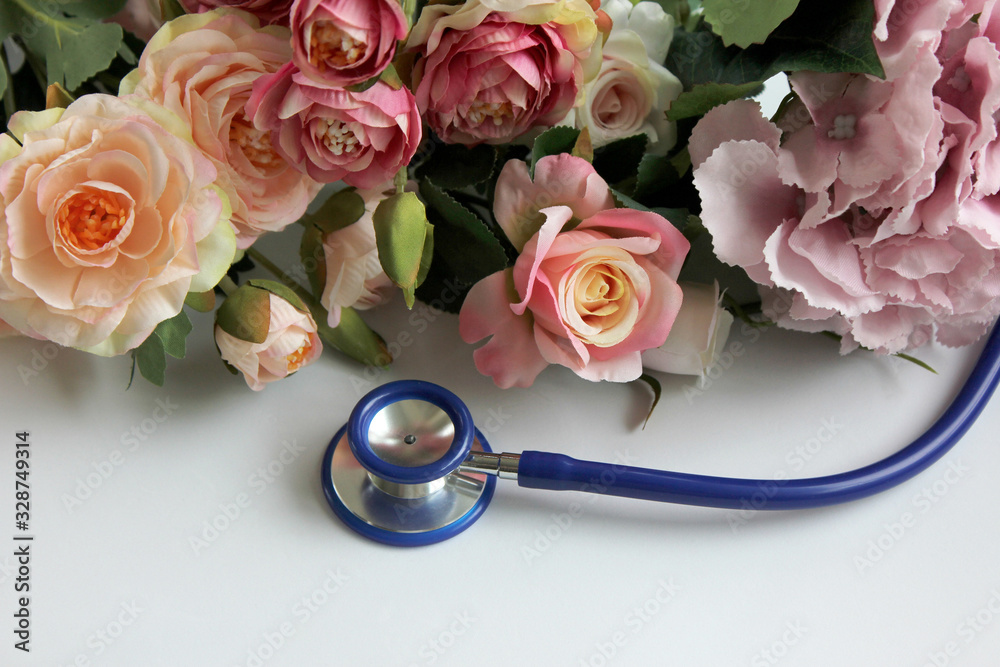 Stethoscope and flowers on white background. Doctor's day and World health day. Creative medical background, postcard. Top view, flat lay, copy space. Stethoscope and flowers on white background. Doctor's day and World health day. Creative medical background, postcard. Top view, flat lay, copy space.