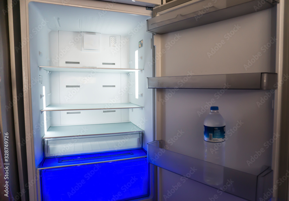 Empty fridge or refrigerator at home. Poverty / poorness concept. No food and money. Empty fridge or refrigerator at home. Poverty / poorness concept. No food and money.