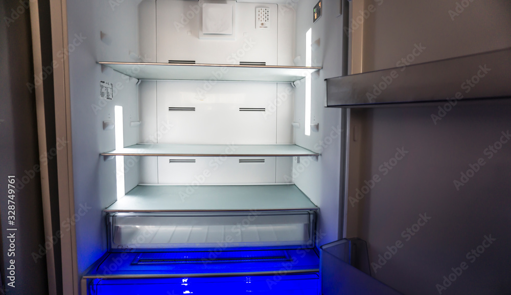 Empty fridge or refrigerator at home. Poverty / poorness concept. No food and money. Empty fridge or refrigerator at home. Poverty / poorness concept. No food and money.