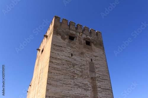 Watch and arms towers of Alcazaba fortress at the historical Alhambra Palace complex in Granada, Andalusia, Spain. photo