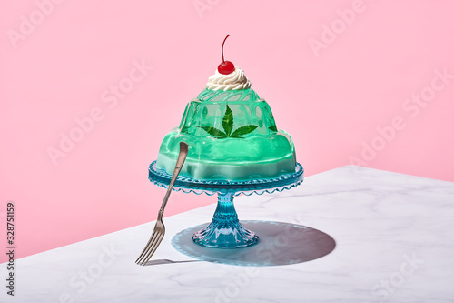 Mello Jello: Edible Arrangement of Cannabis baked into Jello Mold Served on Cake Stand on Marble Counter with Pink Background