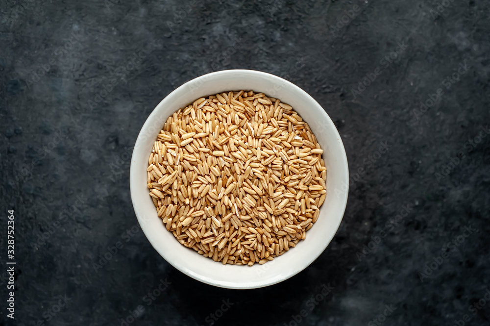 oatmeal grains in a white mask on a stone background oatmeal grains in a white mask on a stone background