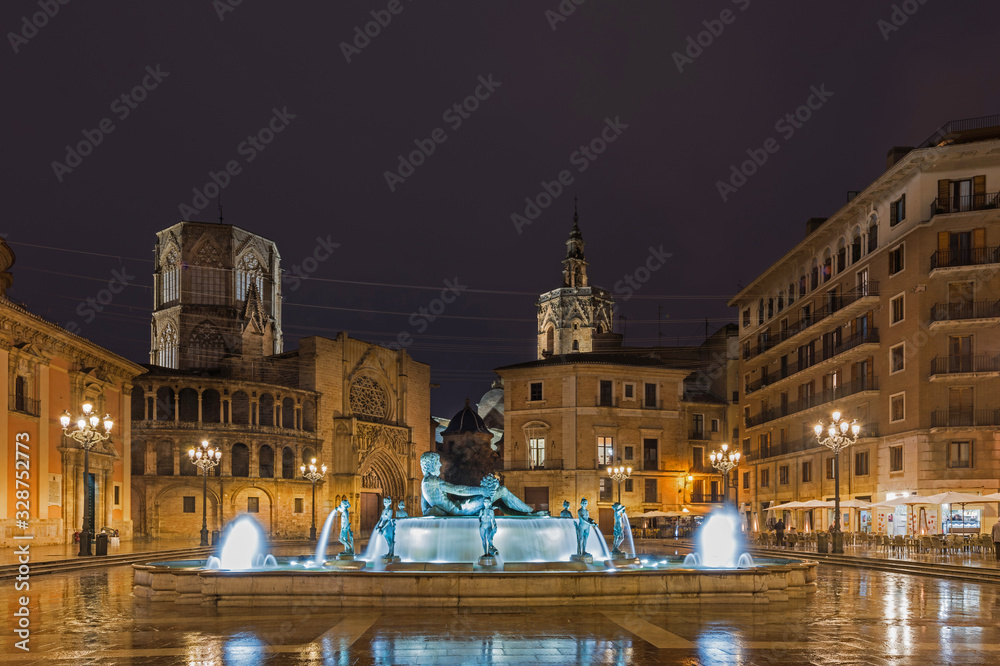 Plaza de la Virgen (Virgen square) and fountain Rio Turia in Valencia at night, Spain