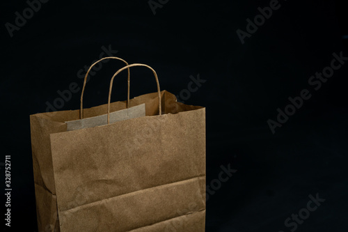 Brown paper bag on black background. Disposal paper bag.