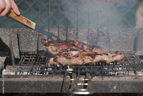 Meat cooked with charcoal on a barbecue