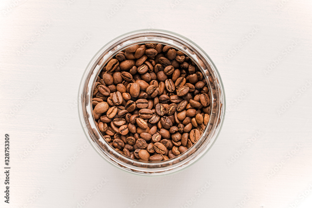 Fresh coffee beans from Ethiopia in a glass jar.