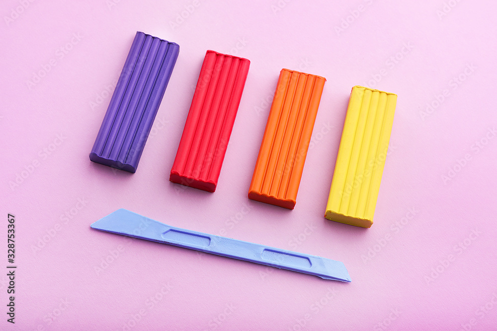 Multi-colored plasticine on purple background Multi-colored plasticine on purple background