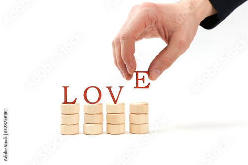 hand makes a word love of letters on white background
