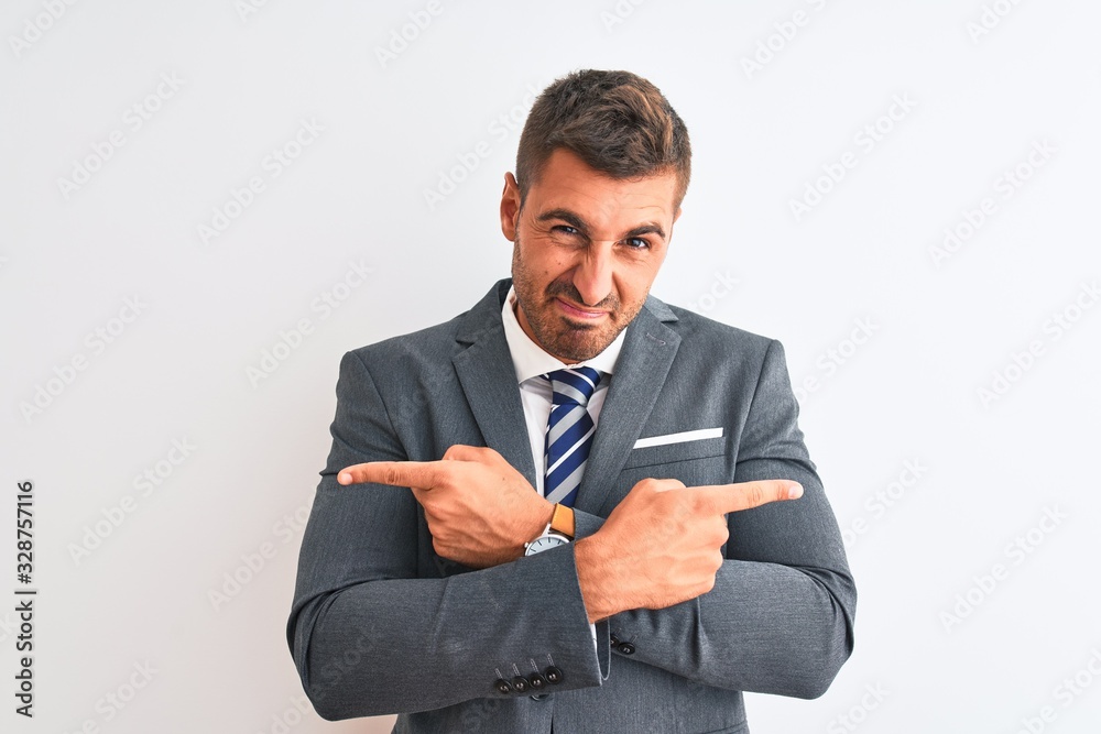 Young handsome business man wearing suit and tie over isolated background Pointing to both sides with fingers, different direction disagree Young handsome business man wearing suit and tie over isolated background Pointing to both sides with fingers, different direction disagree