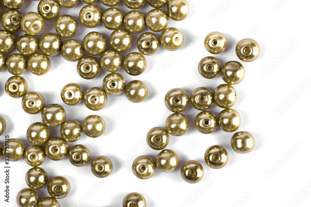 Large brown beads are scattered over a white isolated background